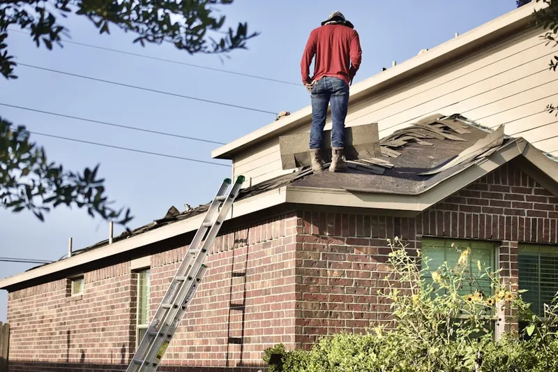 Professional roofer working on a residential roof in Downtown Dallas